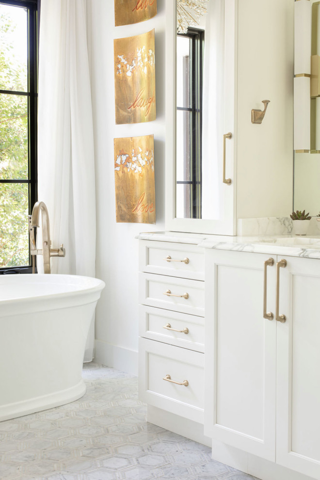 Design ideas for a large transitional master bathroom in Austin with shaker cabinets, white cabinets, a freestanding tub, an alcove shower, a two-piece toilet, white tile, white walls, marble floors, an undermount sink, white floor, a hinged shower door, white benchtops, a shower seat, a double vanity and a built-in vanity.