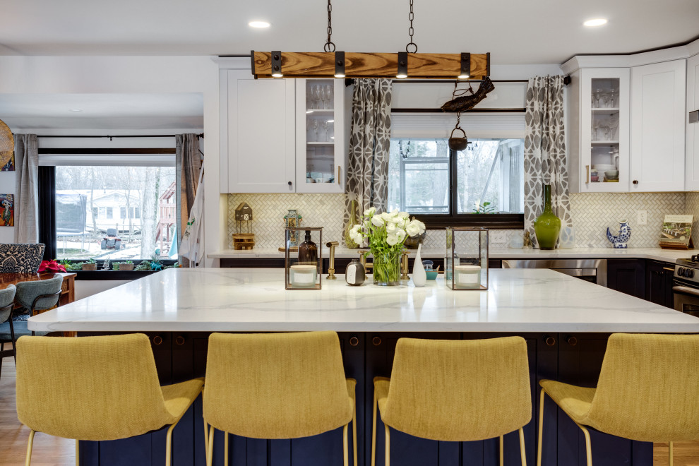 This is an example of a medium sized eclectic l-shaped kitchen/diner in DC Metro with a belfast sink, shaker cabinets, engineered stone countertops, stainless steel appliances, light hardwood flooring and an island.