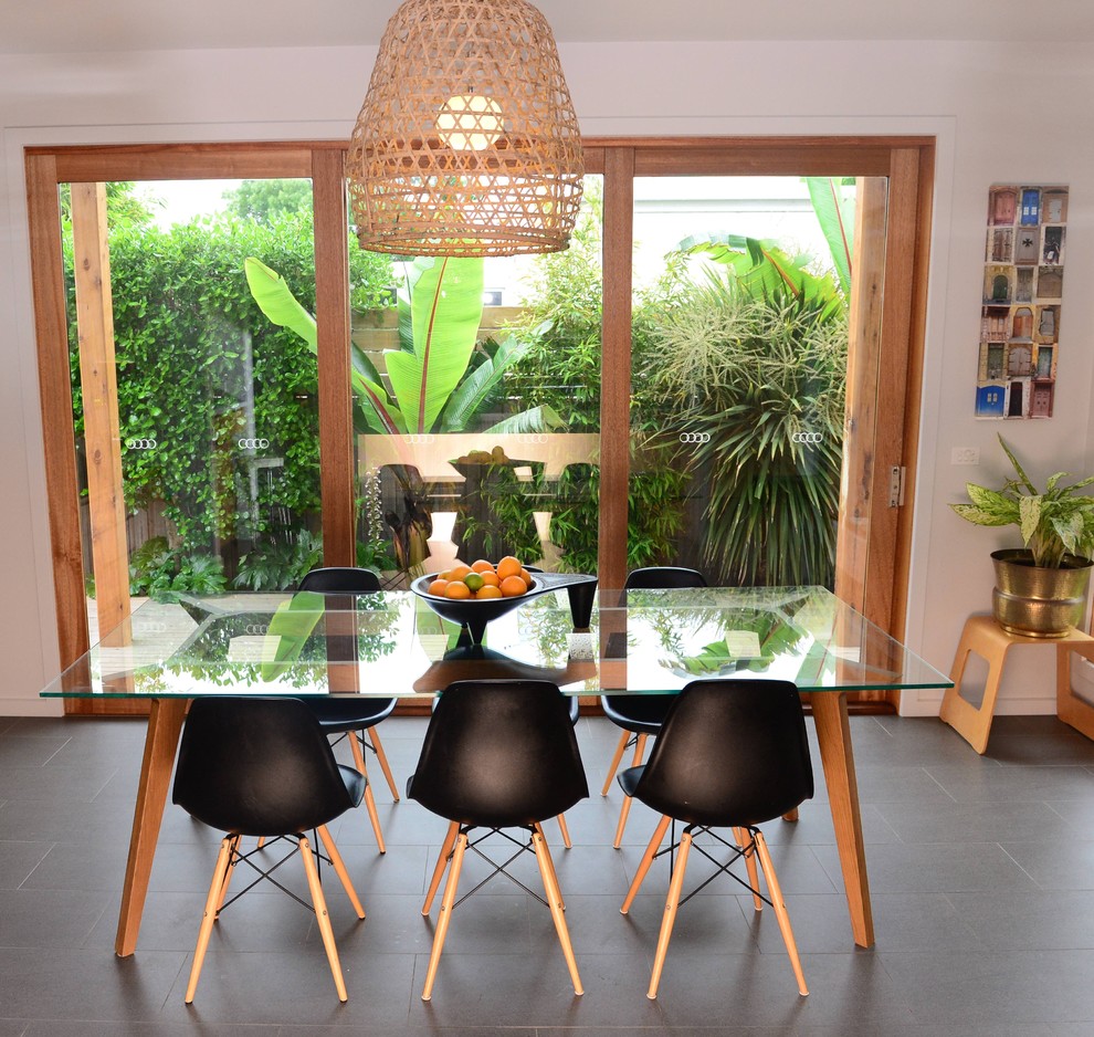 Photo of a beach style dining room in Geelong with ceramic floors.