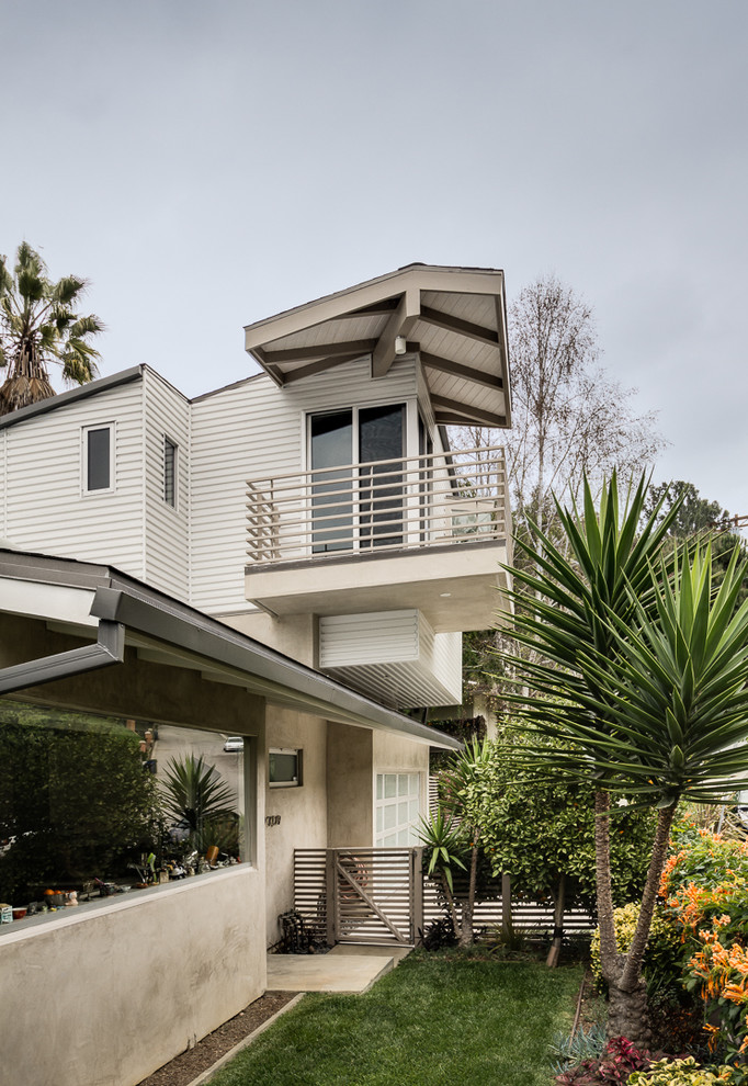 Mid-sized midcentury two-storey exterior in Los Angeles with mixed siding.