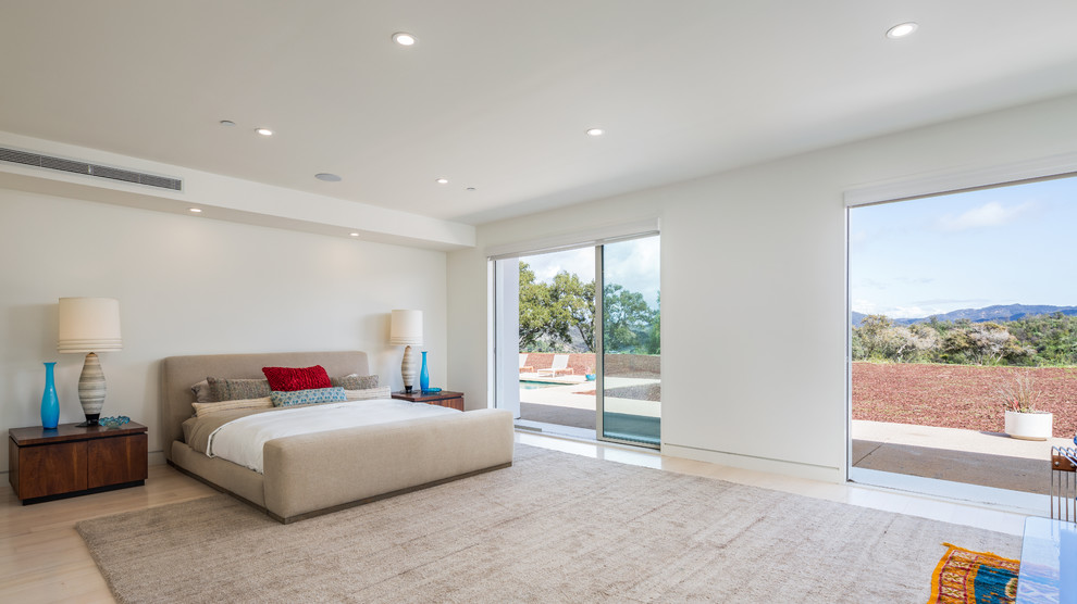 Inspiration for a mid-sized contemporary master bedroom in Los Angeles with white walls, light hardwood floors and beige floor.