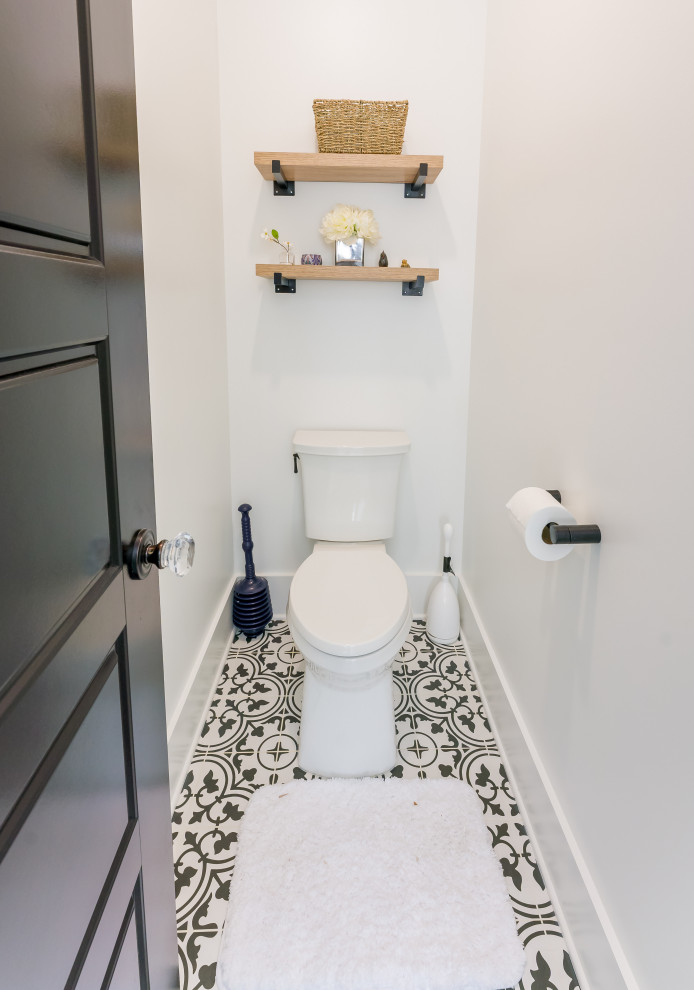 This is an example of a powder room in Raleigh with shaker cabinets, medium wood cabinets, white tile, porcelain tile, white walls, porcelain floors, a vessel sink, engineered quartz benchtops, white benchtops and a freestanding vanity.