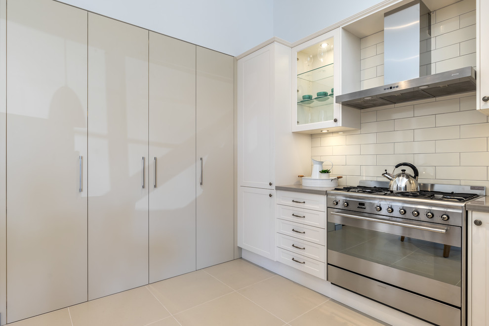 Design ideas for a small contemporary l-shaped separate kitchen in Sydney with a double-bowl sink, shaker cabinets, white cabinets, granite benchtops, white splashback, subway tile splashback, white appliances and no island.