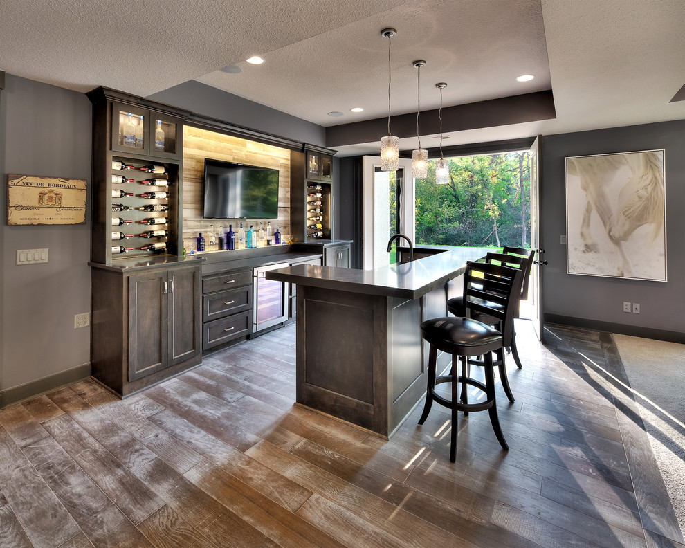 Contemporary seated home bar in Kansas City with flat-panel cabinets, dark wood cabinets and granite benchtops.