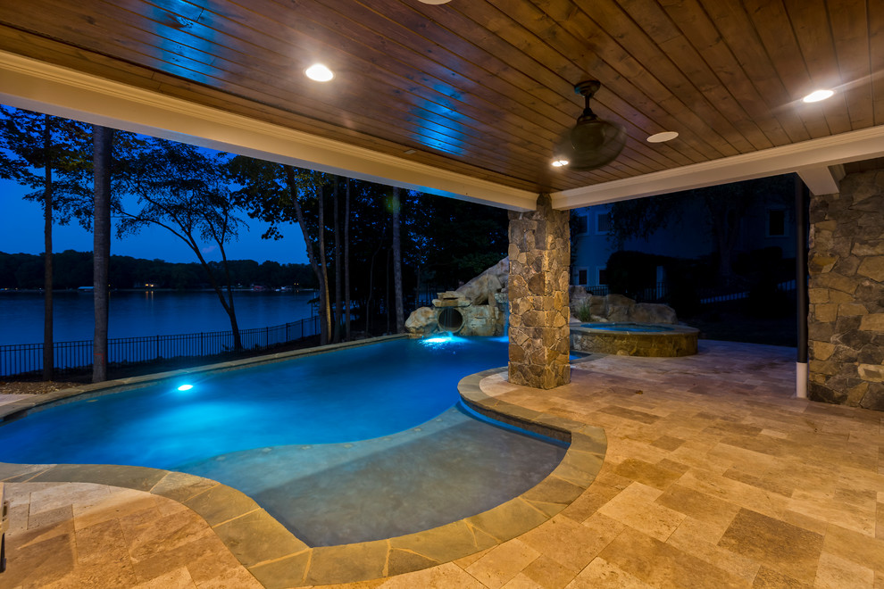 Example of a large mountain style indoor stone and custom-shaped indoor water slide design in Charlotte