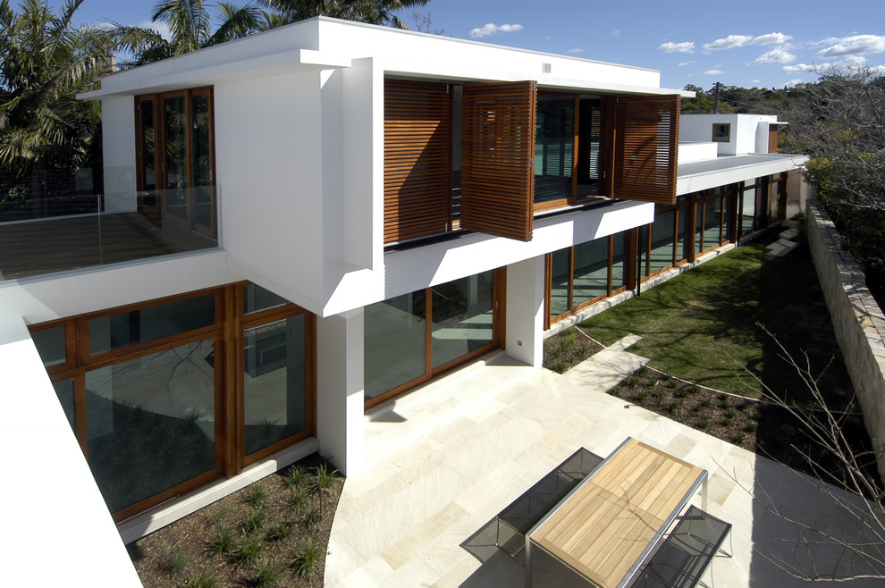Design ideas for a large modern two-storey stucco white exterior in Sydney.