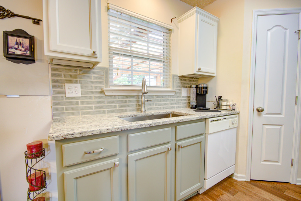 Eat-in kitchen - mid-sized transitional u-shaped medium tone wood floor and brown floor eat-in kitchen idea with an undermount sink, shaker cabinets, green cabinets, granite countertops, green backsplash, ceramic backsplash, white appliances, no island and multicolored countertops