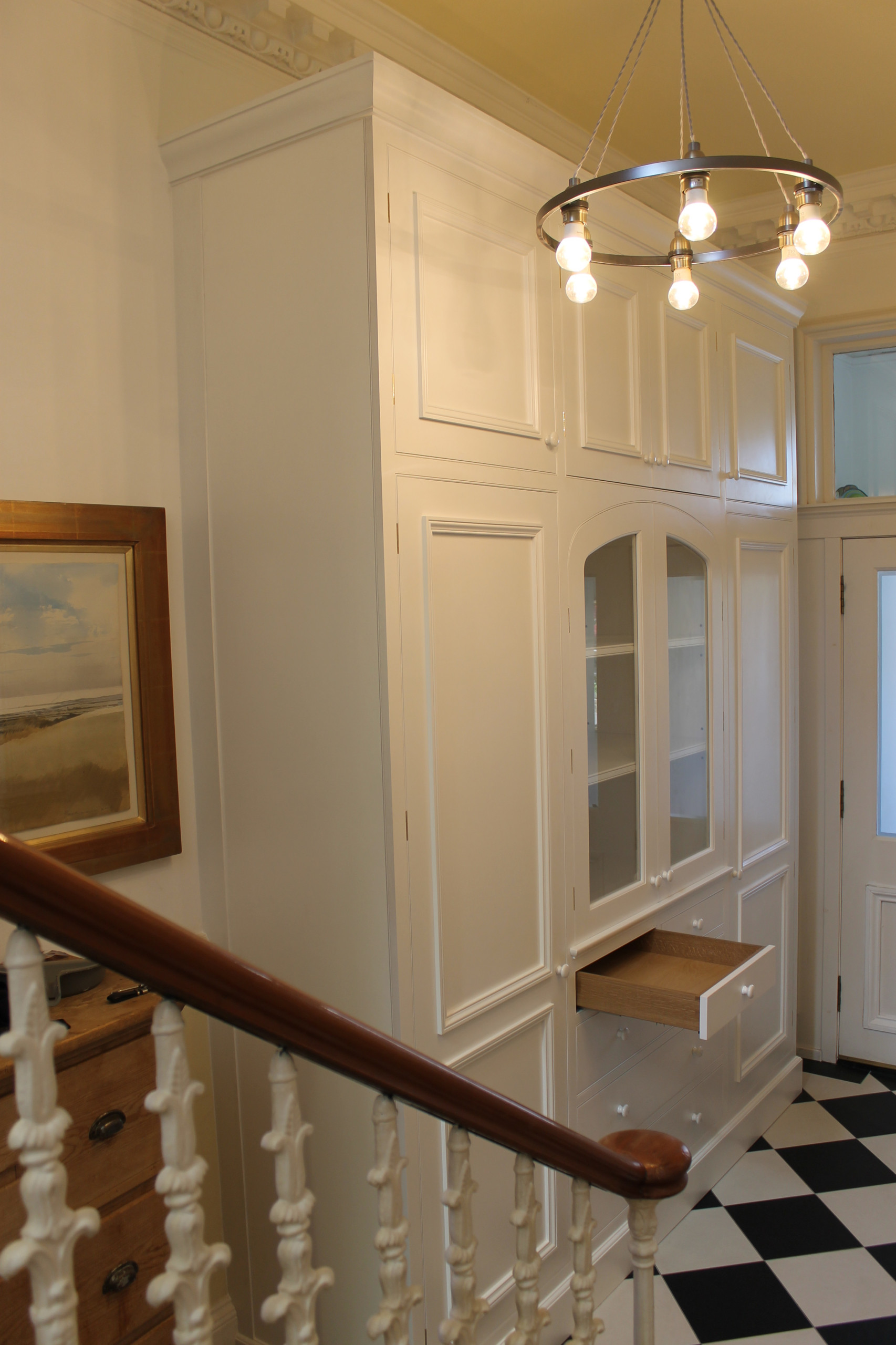 Hallway cabinet with three center arched glazed doors