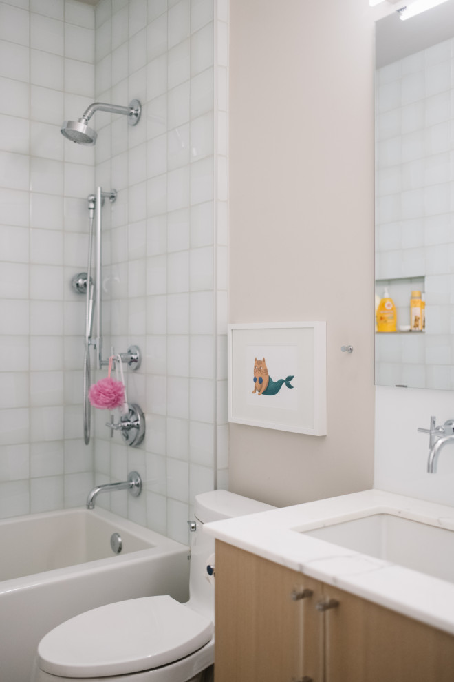 Inspiration for a modern bathroom remodel in Edmonton with light wood cabinets, marble countertops and a floating vanity