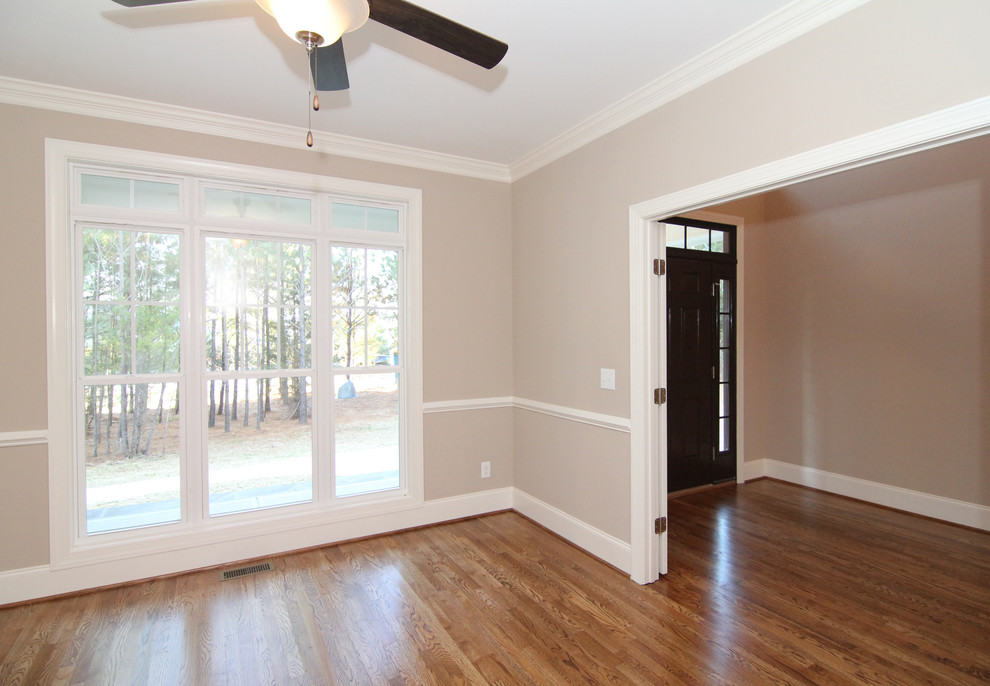 Design ideas for a mid-sized traditional study room in Raleigh with beige walls and medium hardwood floors.