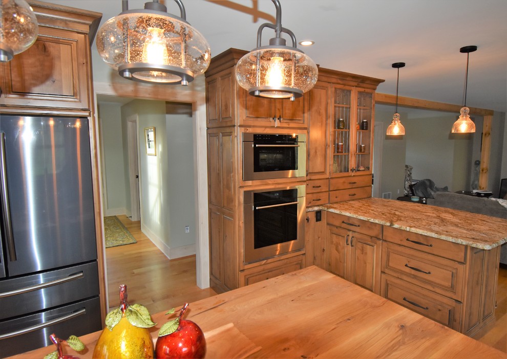 Expansive country kitchen in Other with distressed cabinets.