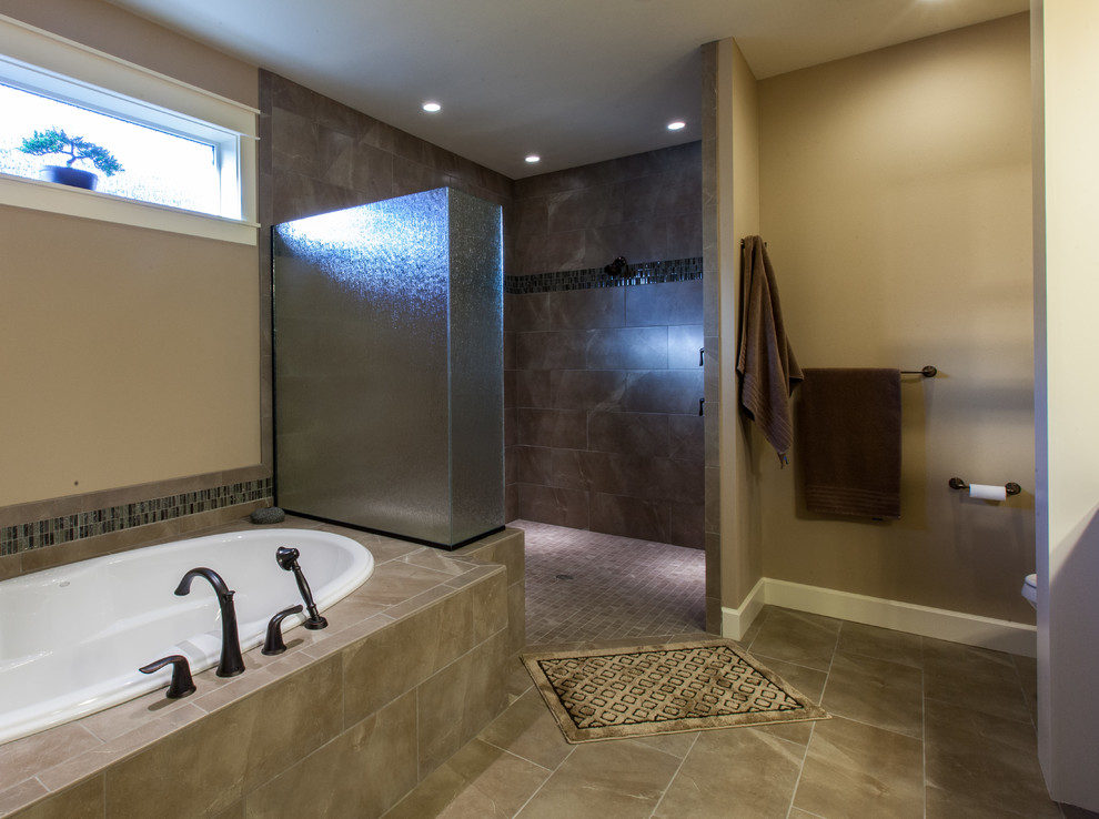 This is an example of a large arts and crafts master bathroom in Portland with an alcove tub, a curbless shower, multi-coloured tile and multi-coloured walls.