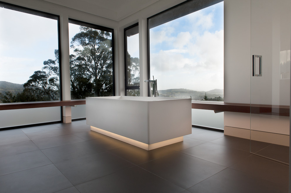Inspiration for a large contemporary master bathroom in San Francisco with flat-panel cabinets, dark wood cabinets, a freestanding tub, a curbless shower, a wall-mount toilet, black tile, porcelain tile, white walls, porcelain floors, an undermount sink and engineered quartz benchtops.
