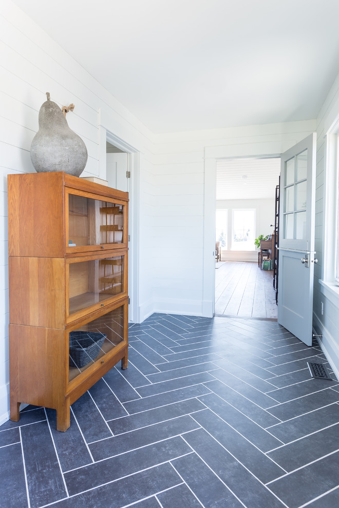Large beach style hallway in Toronto with white walls, slate floors and grey floor.