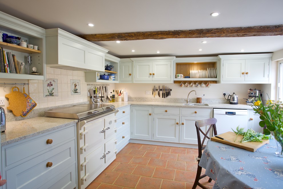 Design ideas for a mid-sized country l-shaped eat-in kitchen in Essex with ceramic splashback, an undermount sink, shaker cabinets, white cabinets, white splashback and white appliances.