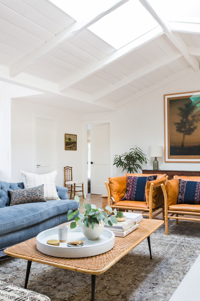 Inspiration for a beach style living room in Los Angeles with white walls and grey floor.
