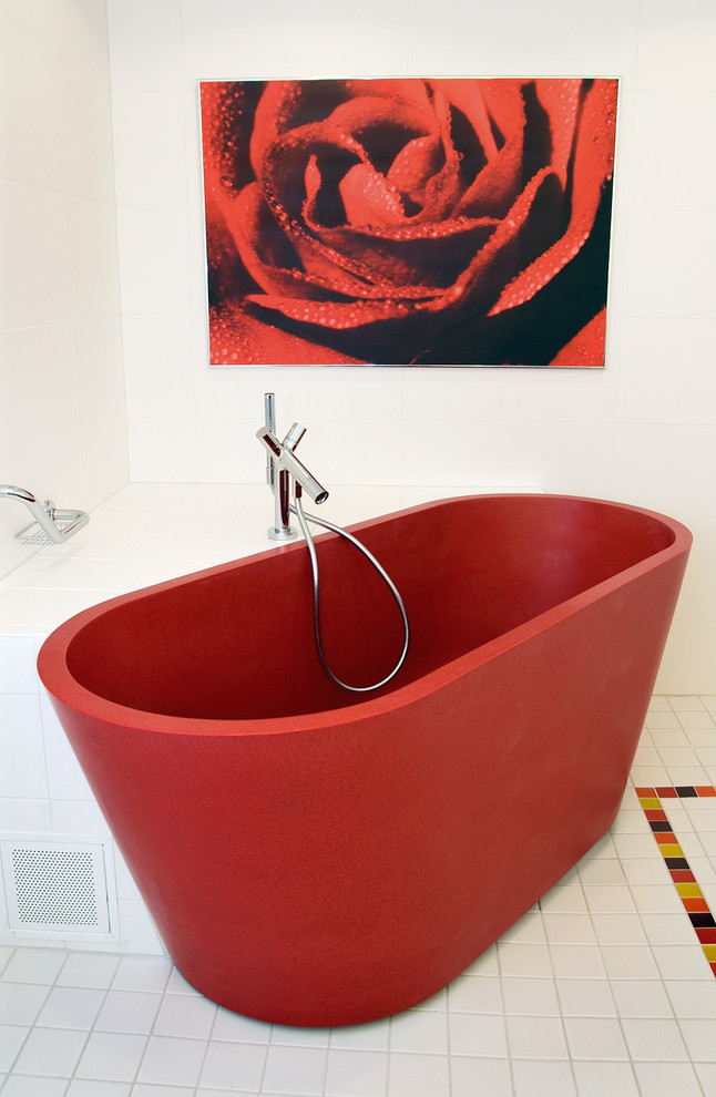 Photo of a traditional bathroom in Other with a freestanding tub, white tile, white walls, porcelain floors and white floor.