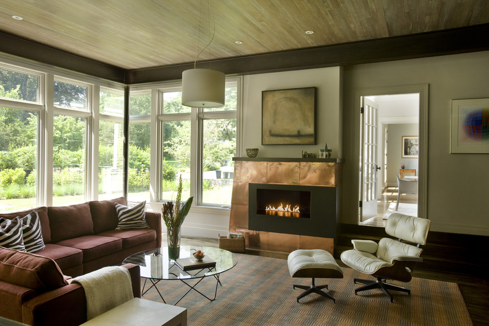 Contemporary living room in Boston with beige walls and a ribbon fireplace.