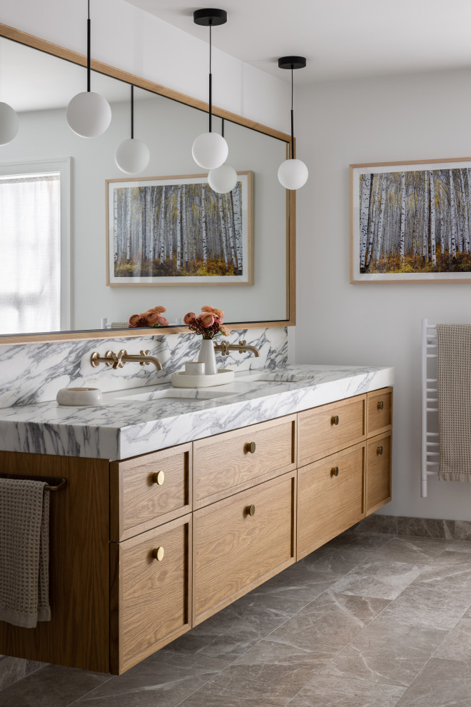 Inspiration for a transitional double-sink bathroom remodel in Kansas City with recessed-panel cabinets, brown cabinets and a floating vanity