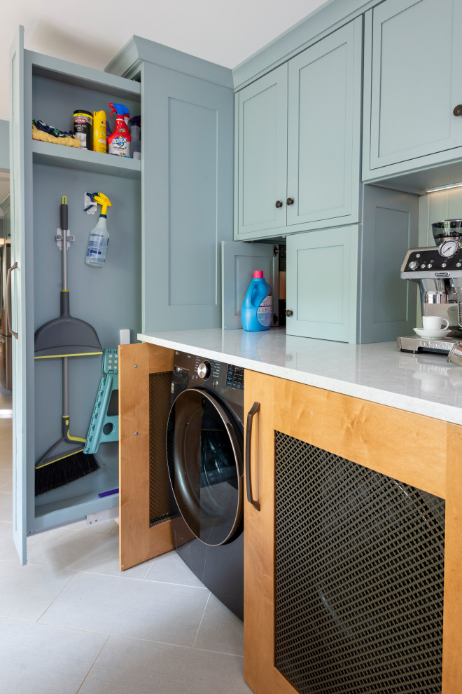 Laundry room - ceramic tile and gray floor laundry room idea with blue cabinets, a side-by-side washer/dryer and white countertops