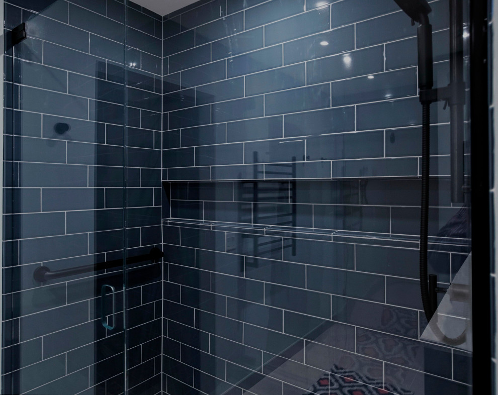 Example of a mid-sized transitional master blue tile and porcelain tile concrete floor, beige floor and double-sink doorless shower design in Chicago with raised-panel cabinets, blue cabinets, a two-piece toilet, blue walls, an undermount sink, quartzite countertops, a hinged shower door, white countertops and a built-in vanity