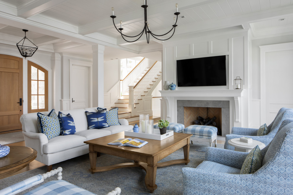 Example of a large transitional open concept medium tone wood floor, brown floor, exposed beam and wood wall living room design in Milwaukee with white walls, a standard fireplace, a brick fireplace and a wall-mounted tv