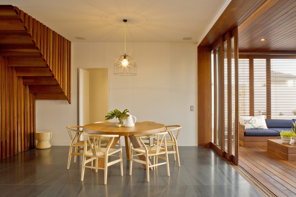 Inspiration for a large contemporary kitchen/dining combo in Sydney with white walls and slate floors.