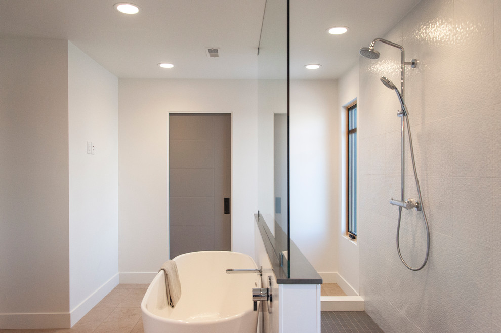 Photo of a mid-sized contemporary master bathroom in Salt Lake City with an undermount sink, furniture-like cabinets, white cabinets, quartzite benchtops, a freestanding tub, an open shower, gray tile, ceramic tile, white walls, limestone floors and an open shower.