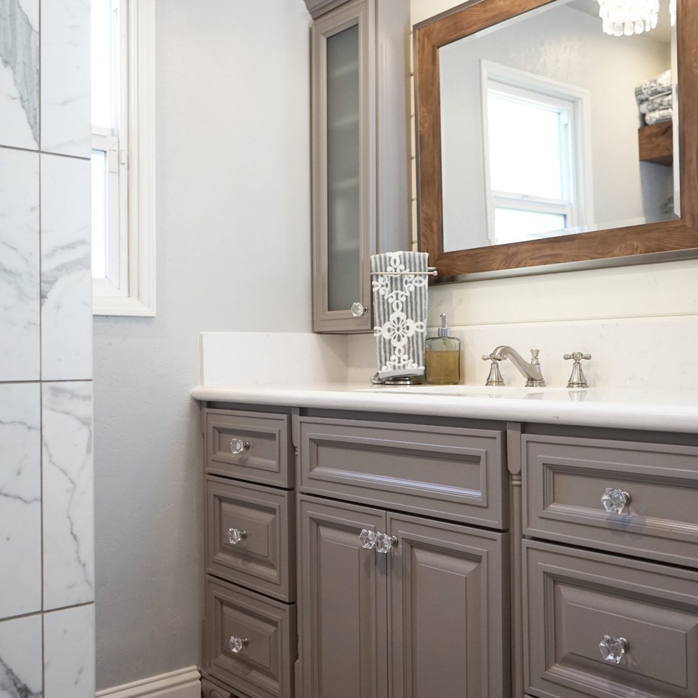 Design ideas for a mid-sized contemporary 3/4 bathroom in Sacramento with raised-panel cabinets, grey cabinets, an alcove shower, a two-piece toilet, marble, grey walls, medium hardwood floors, an undermount sink, engineered quartz benchtops, grey floor, a shower curtain and white benchtops.
