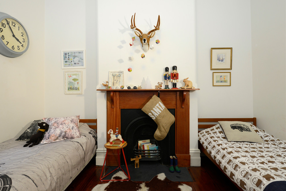 This is an example of an eclectic gender-neutral kids' bedroom for kids 4-10 years old in Adelaide with white walls and dark hardwood floors.