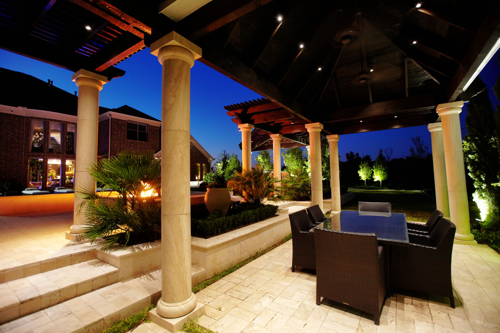 Traditional patio in Dallas with natural stone pavers and a gazebo/cabana.