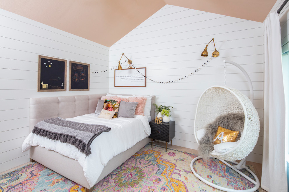 Inspiration for a mid-sized transitional kids' bedroom for girls and kids 4-10 years old in Austin with white walls, medium hardwood floors and brown floor.