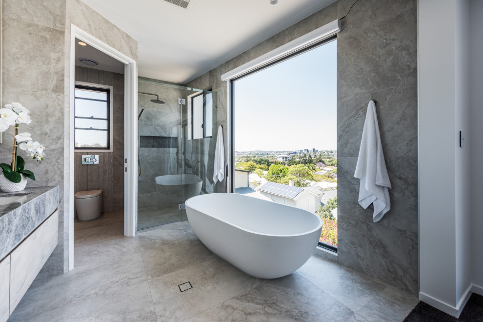 Expansive contemporary bathroom in Brisbane with marble benchtops.