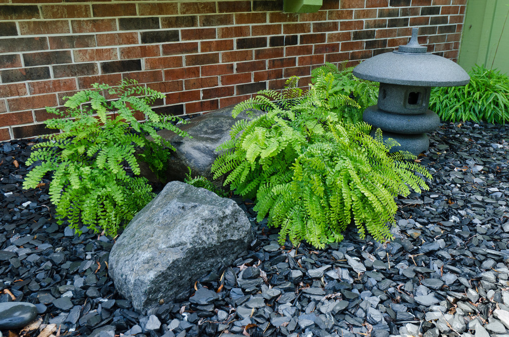 This is an example of a mid-sized asian front yard garden in Milwaukee with gravel.