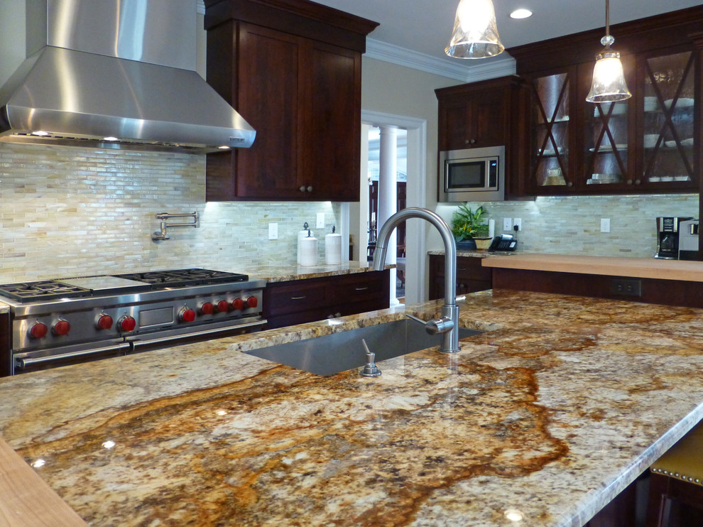 Kitchen - large transitional medium tone wood floor kitchen idea in Richmond with recessed-panel cabinets, dark wood cabinets, granite countertops, beige backsplash, ceramic backsplash, stainless steel appliances and an island