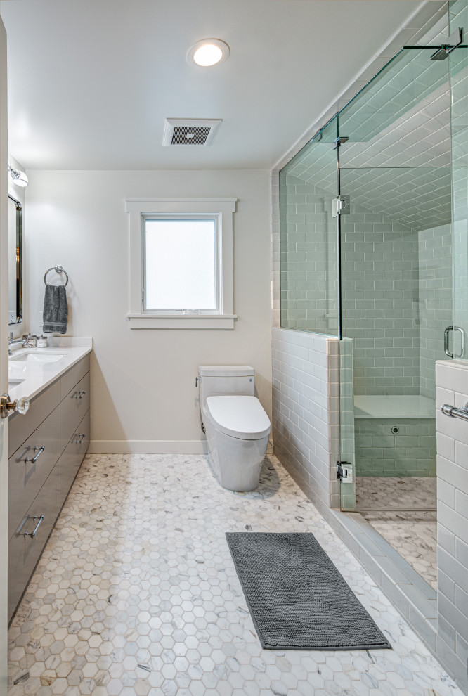 Photo of a large contemporary master bathroom in Portland with flat-panel cabinets, grey cabinets, an alcove shower, a one-piece toilet, gray tile, porcelain tile, grey walls, marble floors, an undermount sink, engineered quartz benchtops, grey floor, a hinged shower door and white benchtops.