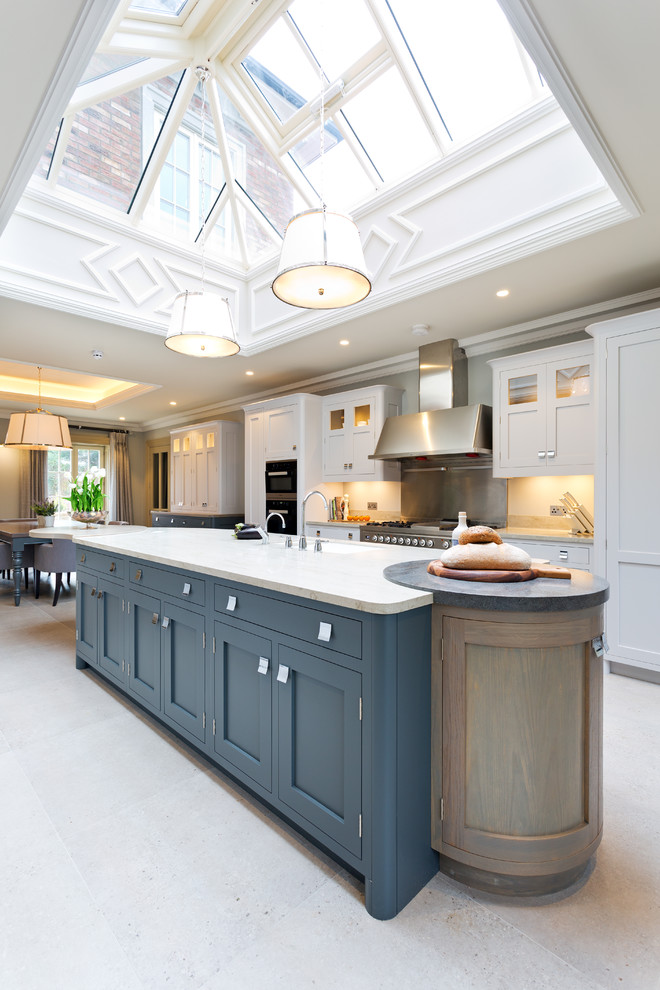 Design ideas for a transitional kitchen in Belfast with an undermount sink, recessed-panel cabinets, blue cabinets, stainless steel appliances and with island.