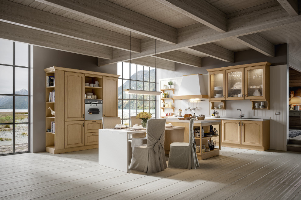 Design ideas for a mid-sized traditional u-shaped eat-in kitchen in San Diego with an integrated sink, beaded inset cabinets, medium wood cabinets, quartzite benchtops, beige splashback, ceramic splashback, white appliances, light hardwood floors, with island and brown floor.