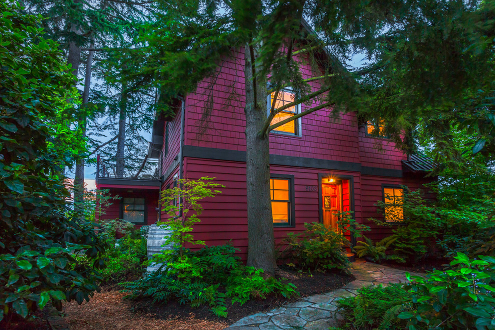 This is an example of a beach style red exterior in Seattle.