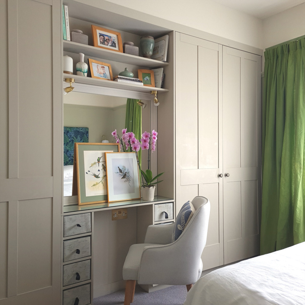 This is an example of a mid-sized eclectic master bedroom in Other with green walls and carpet.