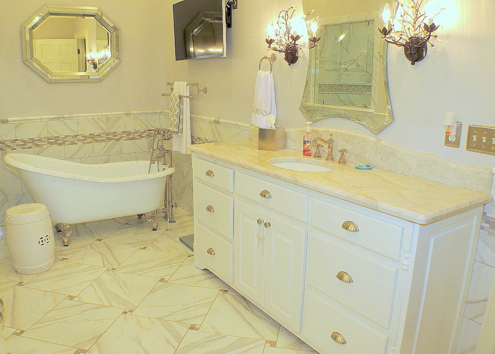 This is an example of a mid-sized traditional master bathroom in Other with an undermount sink, white cabinets, quartzite benchtops, a freestanding tub, white tile, porcelain tile, grey walls and porcelain floors.