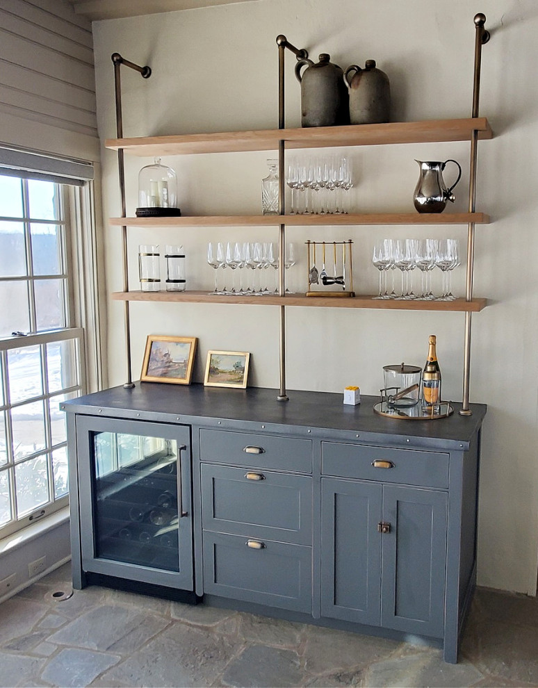 This is an example of an urban home bar in New York with shaker cabinets.