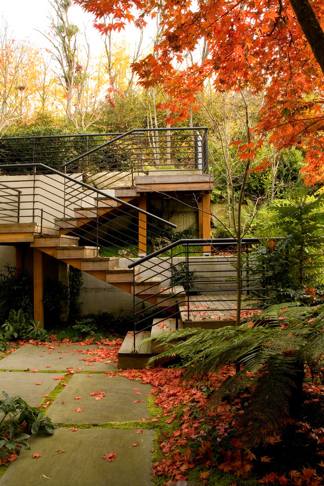 This is an example of an arts and crafts sloped garden for fall in Seattle with concrete pavers.