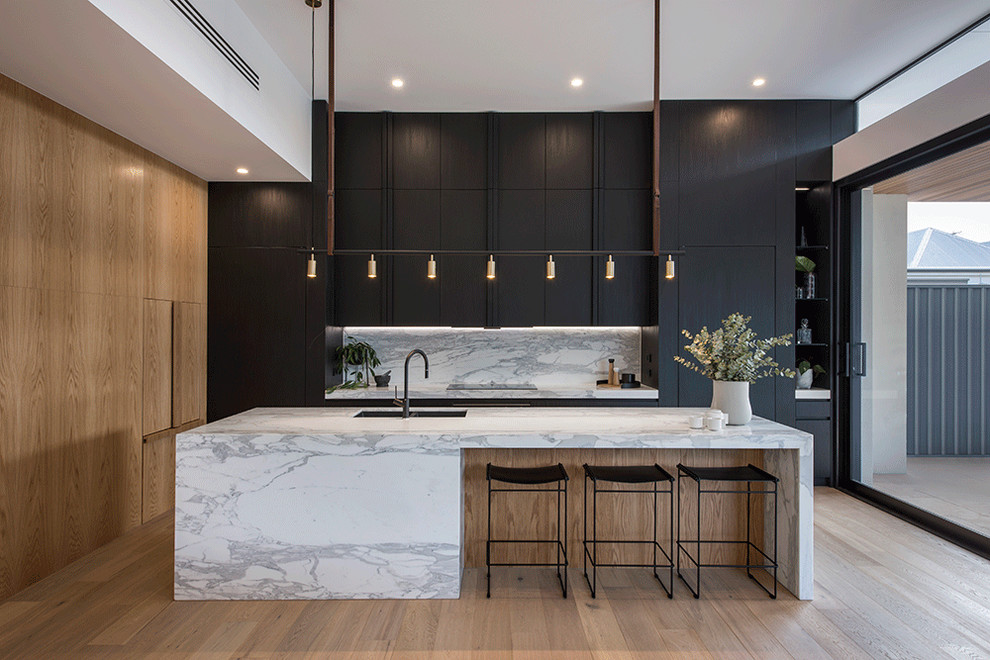Design ideas for a contemporary kitchen in Adelaide with a double-bowl sink, flat-panel cabinets, black cabinets, marble benchtops, white splashback, marble splashback, panelled appliances, light hardwood floors, with island, beige floor and white benchtop.