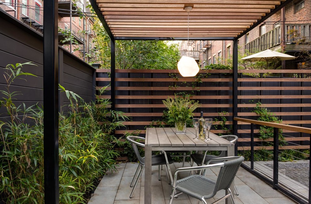 Inspiration for a contemporary patio in Boston with a pergola.