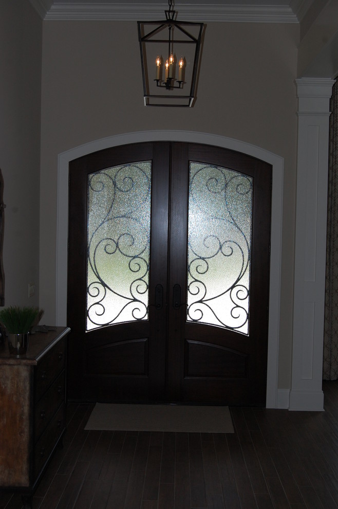 Example of a large mountain style brick floor front door design in Miami with white walls and a dark wood front door