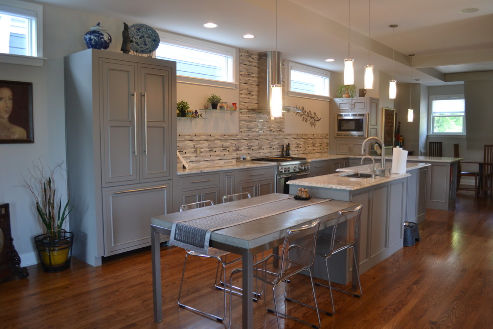 Open concept kitchen - large transitional l-shaped medium tone wood floor open concept kitchen idea in Cincinnati with an undermount sink, gray cabinets, granite countertops, multicolored backsplash, mosaic tile backsplash, stainless steel appliances, an island and beaded inset cabinets