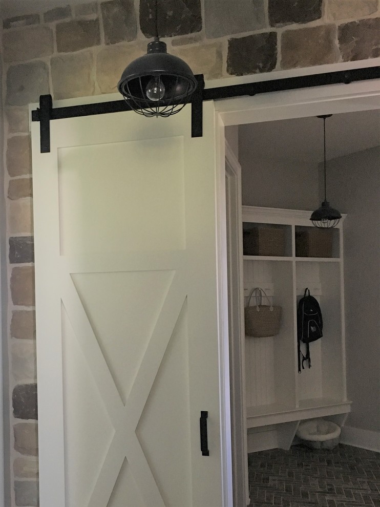 Small transitional dark wood floor and brown floor mudroom photo with gray walls