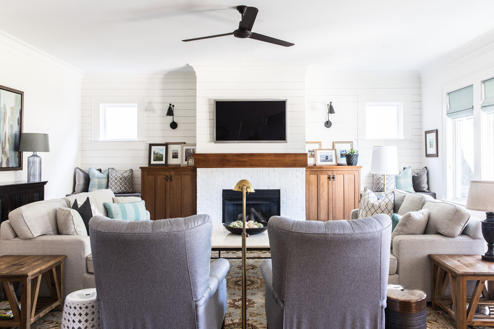 Inspiration for a transitional family room in Charlotte with white walls, a standard fireplace, a brick fireplace surround and a wall-mounted tv.