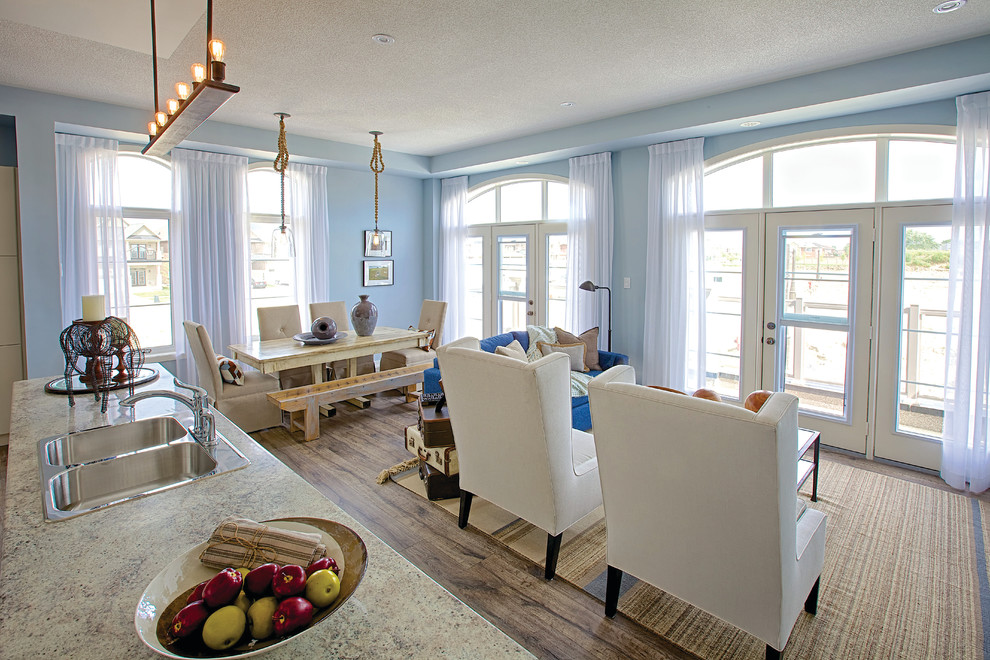 This is an example of a traditional open concept living room in Toronto with blue walls.